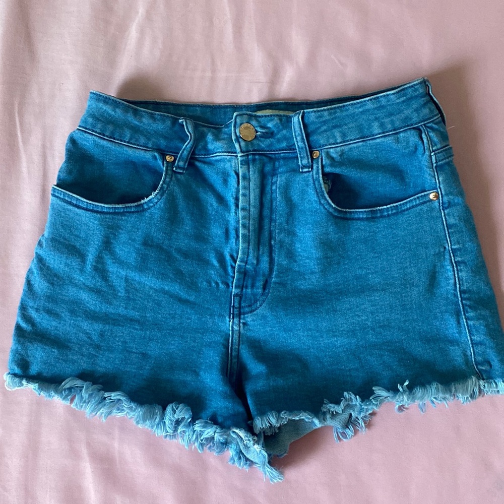 Blue denim shorts with fringe detail